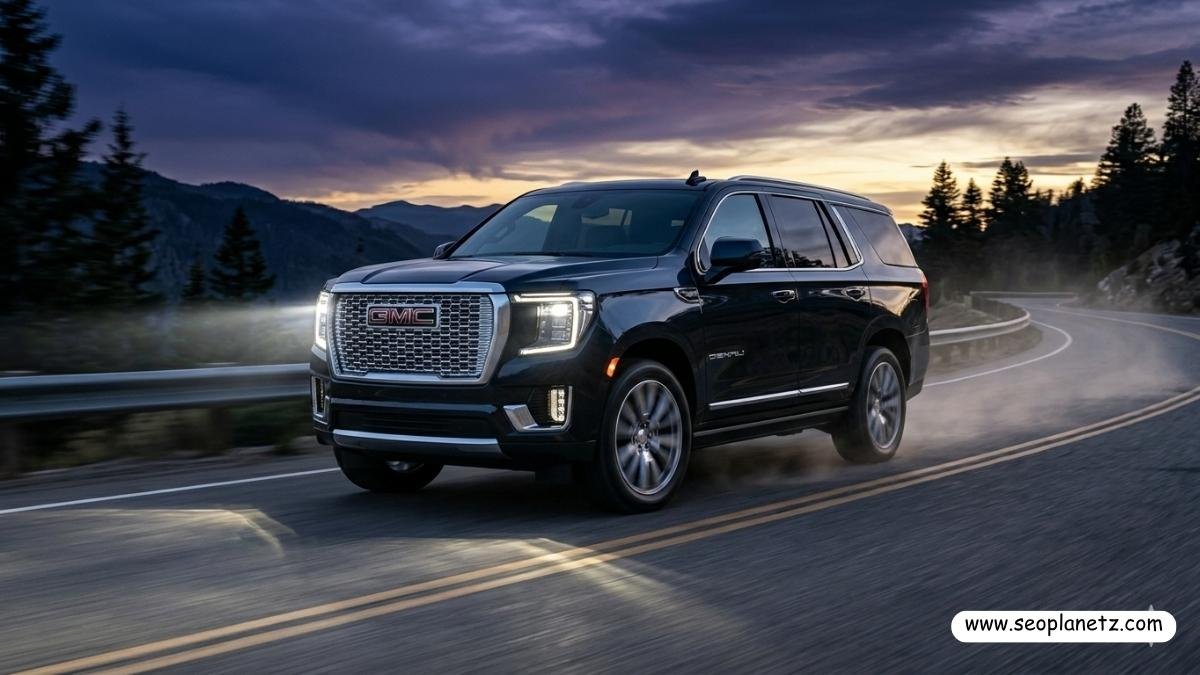 2027 GMC Yukon Denali in Midnight Blue Metallic on mountain highway at dusk
