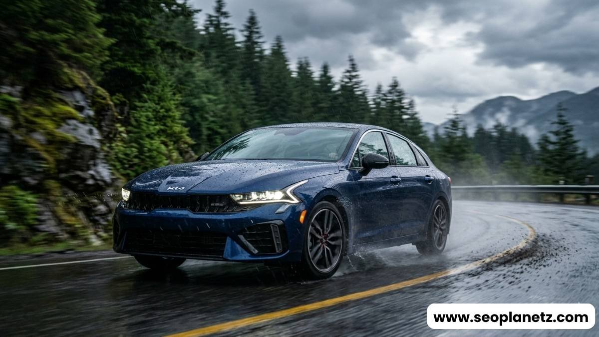 2027 Kia K5 GT Line E-AWD cornering on wet mountain road